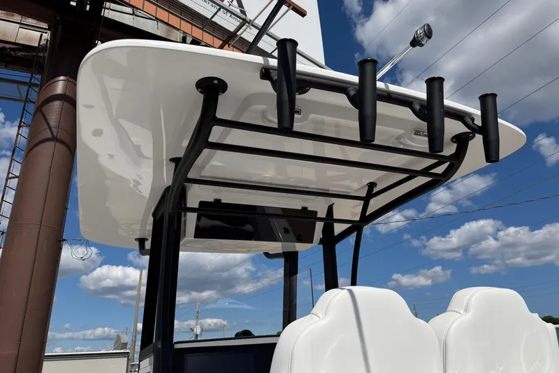 Slide: The Image of 2026 Bluewater Sportfishing 25T boat with rod holders under a clear blue sky. - 16