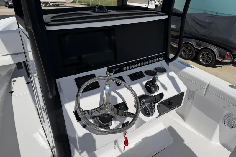 Slide: The Image of 2026 Bluewater Sportfishing 25T boat console with steering wheel and controls. - 17
