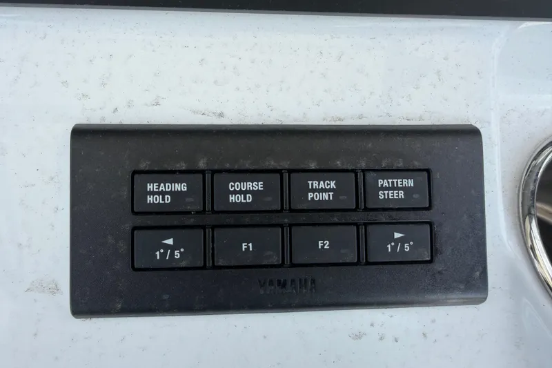 Slide: The Image of Control panel on a 2026 Bluewater Sportfishing 25T boat with navigation buttons. - 20