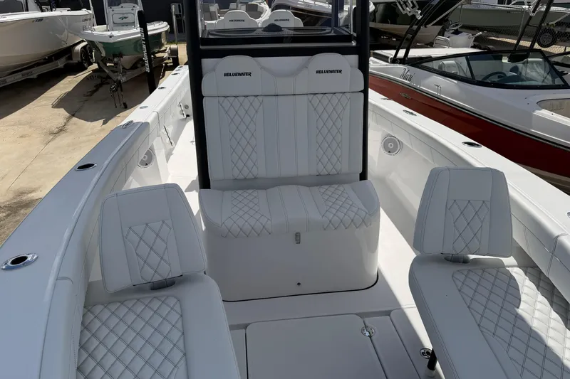 Slide: The Image of 2026 Bluewater Sportfishing 25T boat interior with white quilted seating and sleek design. - 27