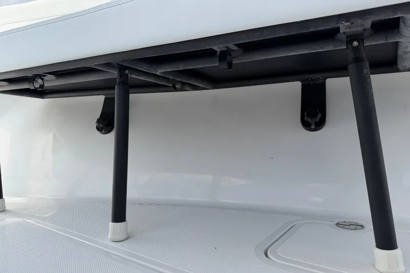 Slide: The Image of 2026 Bluewater Sportfishing 25T boat seating area with sturdy black support legs. - 29