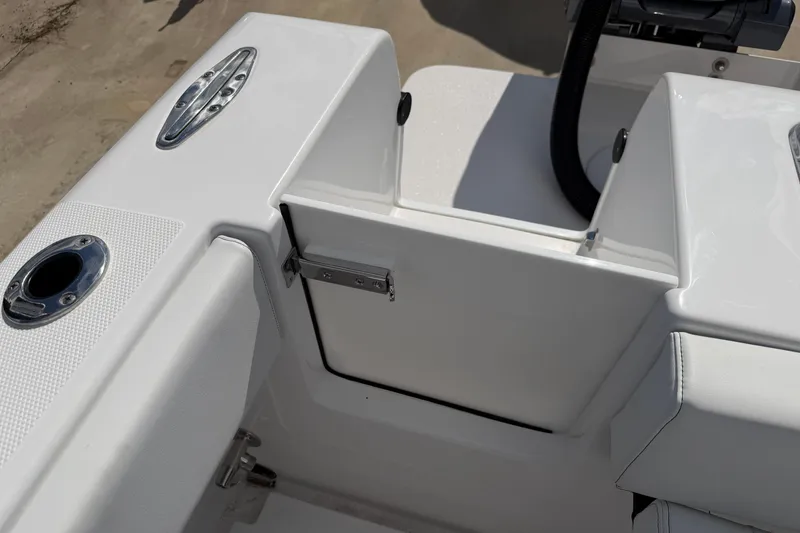 Slide: The Image of 2026 Bluewater Sportfishing 25T boat interior, featuring sleek white seating and stainless steel fixtures. - 33