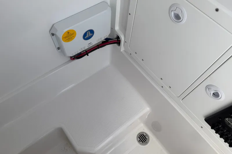 Slide: The Image of Interior view of 2026 Bluewater Sportfishing 25T boat, featuring storage compartments and wiring. - 40