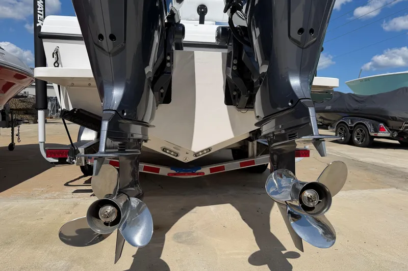 Slide: The Image of 2026 Bluewater Sportfishing 25T boat with dual outboard motors on a trailer. - 5