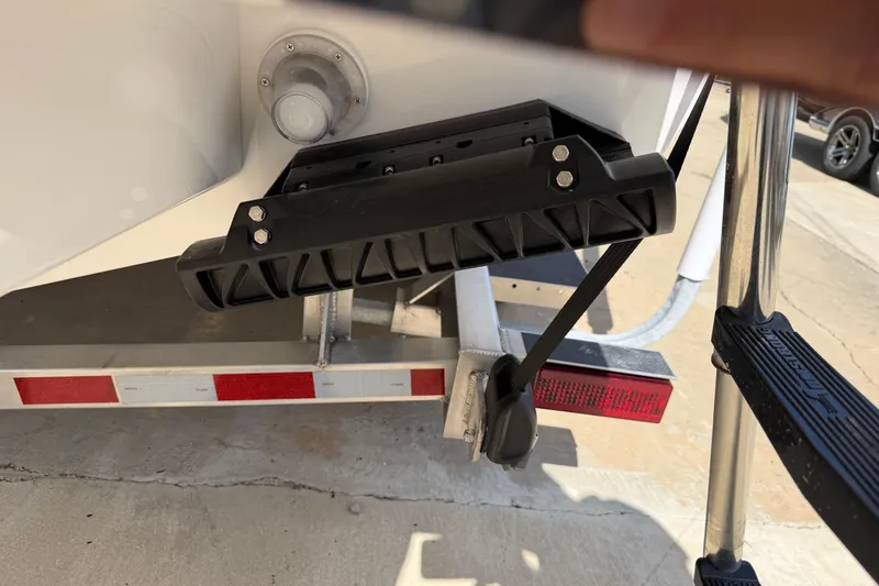 Slide: The Image of Rear view of 2026 Bluewater Sportfishing 25T boat on trailer, showing trim tab and ladder. - 7