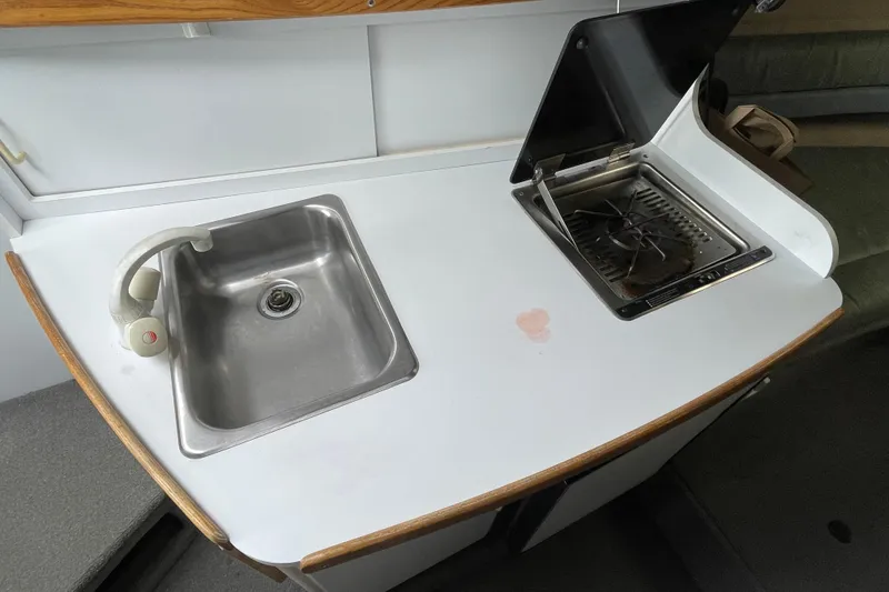 Slide: The Image of 1994 Four Winns 258 Vista boat kitchenette with sink and stove. - 5
