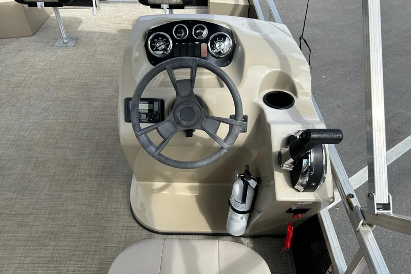Slide: The Image of 2023 Lowe Ultra 162 Fish & Cruise boat helm with steering wheel and controls. - 12