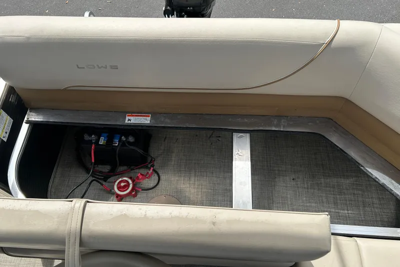 Slide: The Image of 2023 Lowe Ultra 162 Fish & Cruise boat interior with battery compartment and seating. - 16