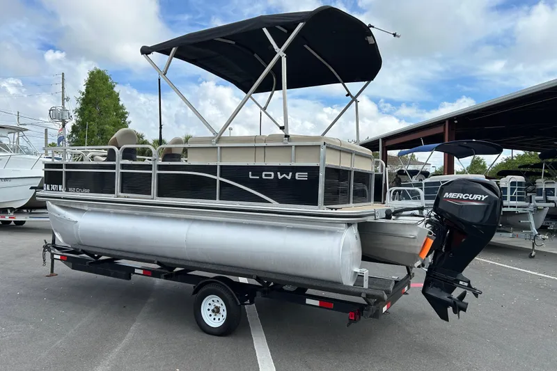 Slide: The Image of 2023 Lowe Ultra 162 Fish & Cruise pontoon boat with Mercury outboard motor on trailer. - 4