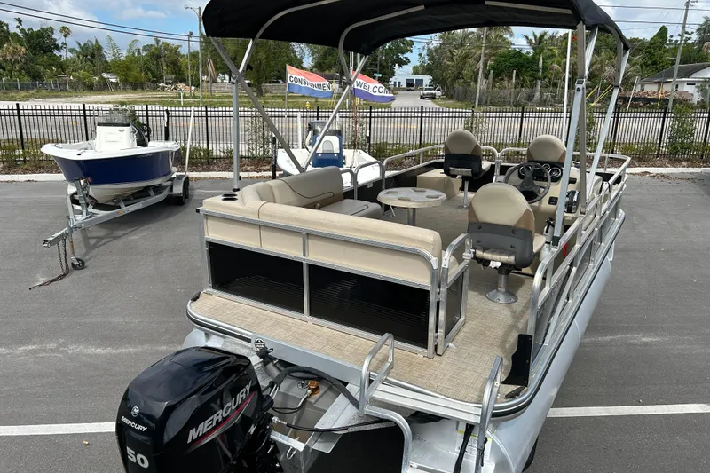 Slide: The Image of 2023 Lowe Ultra 162 Fish & Cruise pontoon boat with Mercury engine, parked outdoors. - 8