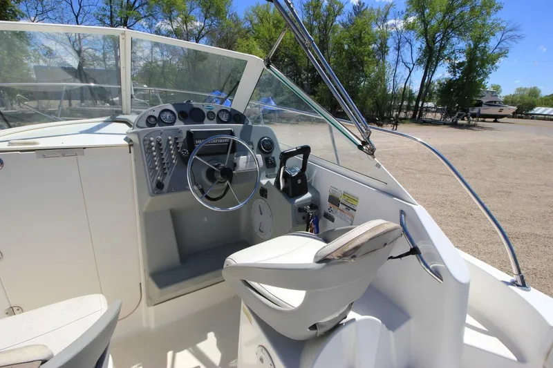 Slide: The Image of 2008 Trophy 2302 Walkaround boat cockpit with steering wheel and control panel. - 12