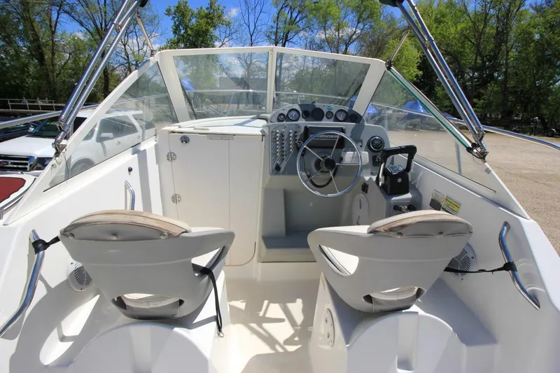 Slide: The Image of 2008 Trophy 2302 Walkaround boat interior with steering wheel and seating. - 13