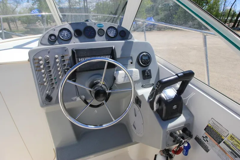 Slide: The Image of 2008 Trophy 2302 Walkaround boat dashboard with steering wheel and controls. - 14