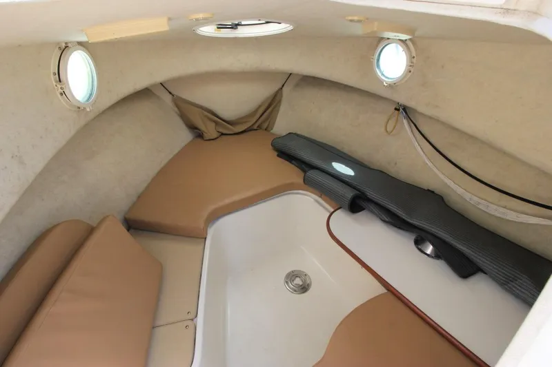 Slide: The Image of Interior cabin of 2008 Trophy 2302 Walkaround boat with beige cushions and portholes. - 17