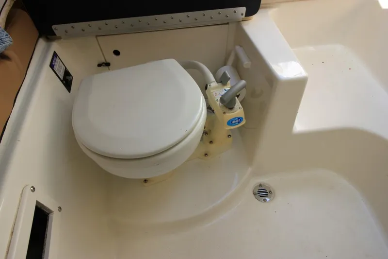 Slide: The Image of 2008 Trophy 2302 Walkaround boat toilet with manual pump system. - 20