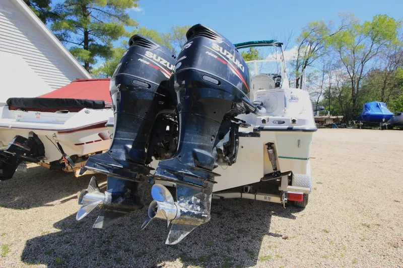 Slide: The Image of 2008 Trophy 2302 Walkaround boat with dual Suzuki outboard motors in a sunny outdoor setting. - 4