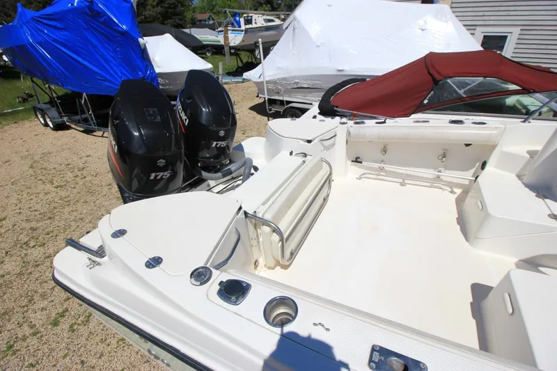 Slide: The Image of 2008 Trophy 2302 Walkaround boat with dual Suzuki 175 engines, parked outdoors. - 7