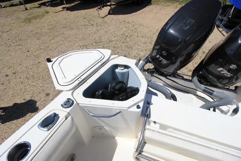 Slide: The Image of 2008 Trophy 2302 Walkaround boat with open storage compartment and dual Suzuki 175 engines. - 8