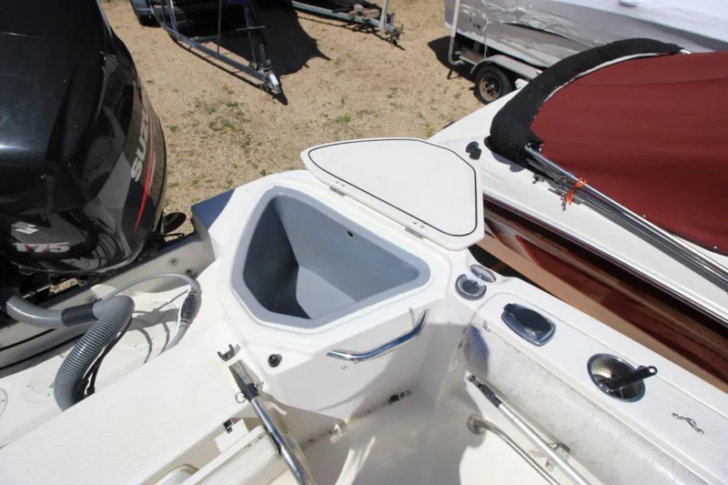 Slide: The Image of 2008 Trophy 2302 Walkaround boat with open storage compartment and Suzuki engine. - 9