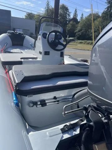 Slide: The Image of 2026 Zodiac Boats Open 4.2, modern design, parked outdoors. - 6