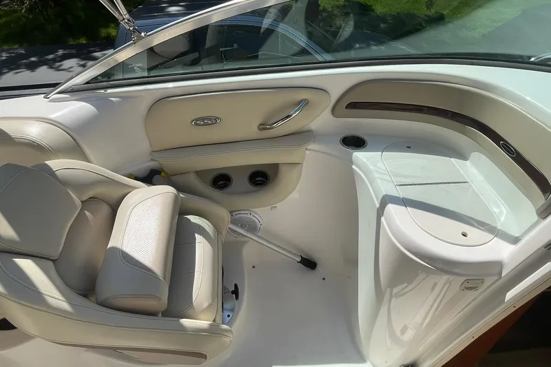 Slide: The Image of Interior of a 2005 Chaparral 265 SSi boat, featuring beige seating and sleek design. - 10