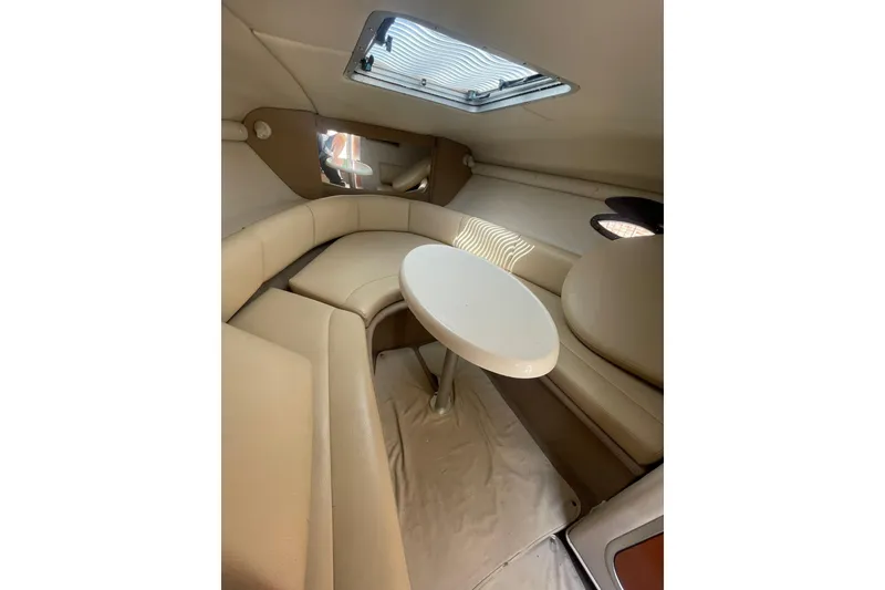 Slide: The Image of Interior of 2005 Chaparral 265 SSi boat with beige seating and round table. - 15