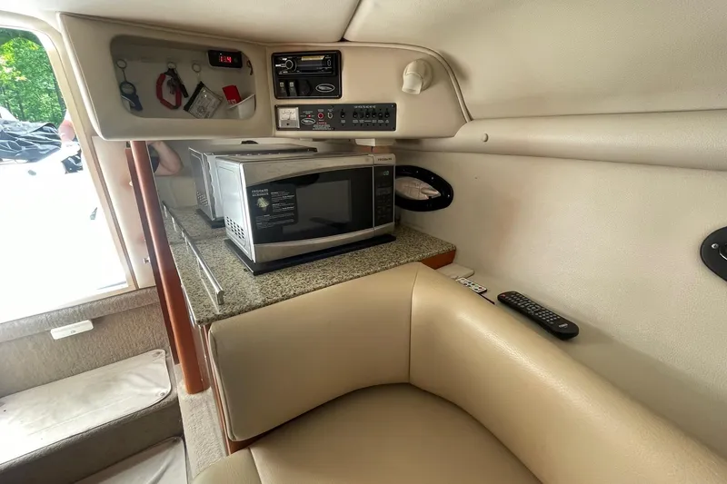 Slide: The Image of Interior of 2005 Chaparral 265 SSi boat with microwave and control panel. - 16