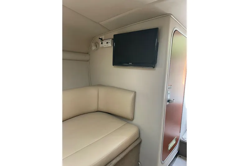 Slide: The Image of Interior of 2005 Chaparral 265 SSi boat with beige seating and wall-mounted TV. - 17