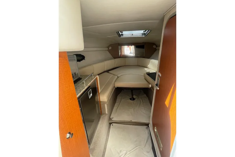 Slide: The Image of Interior of 2005 Chaparral 265 SSi boat with cozy seating and compact kitchenette. - 19