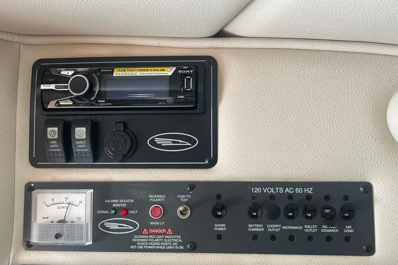 Slide: The Image of Control panel of a 2005 Chaparral 265 SSi boat with audio system and switches. - 23