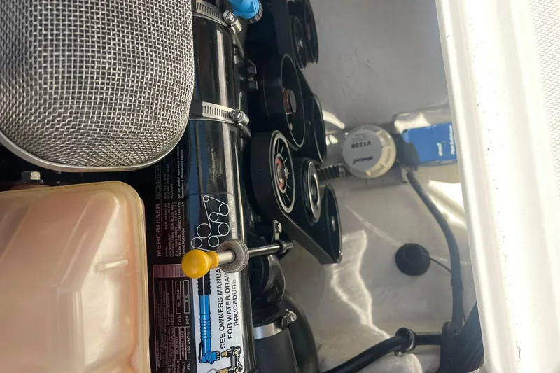Slide: The Image of Engine compartment of a 2005 Chaparral 265 SSi boat, featuring MerCruiser components. - 27