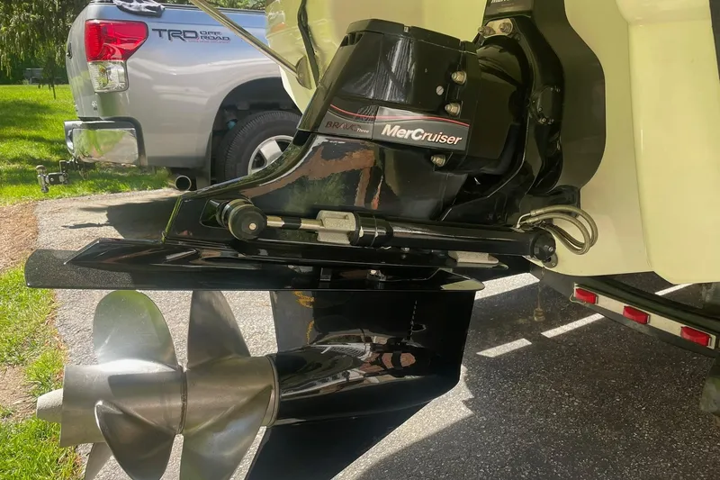 Slide: The Image of 2005 Chaparral 265 SSi boat with MerCruiser Bravo Three outdrive, parked near a truck. - 29