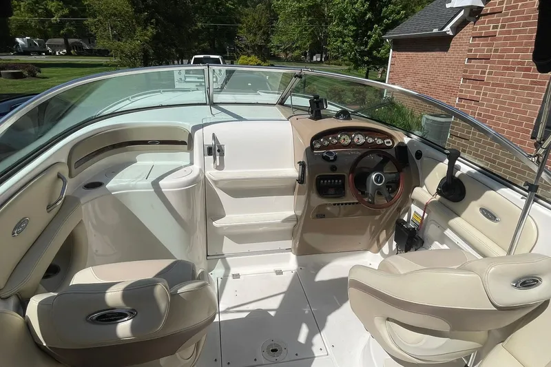 Slide: The Image of Interior view of a 2005 Chaparral 265 SSi boat, featuring a sleek dashboard and seating. - 8
