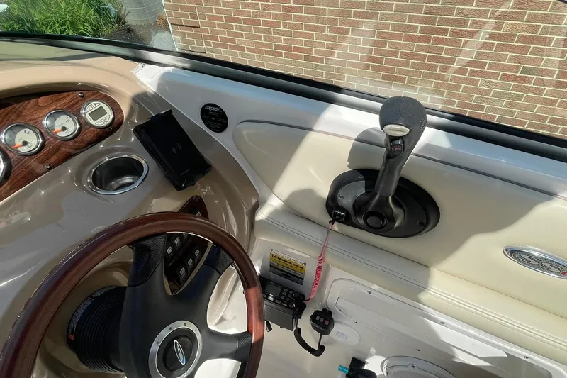 Slide: The Image of 2005 Chaparral 265 SSi boat dashboard with steering wheel and control panel. - 9