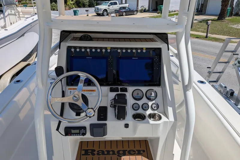Slide: The Image of 2023 Ranger 2660 Bay boat console with steering wheel and navigation screens. - 7