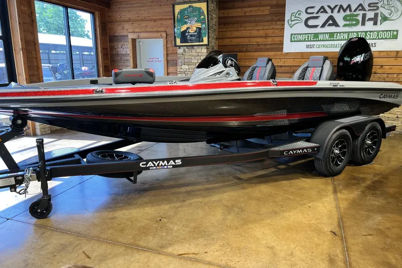 Slide: The Image of 2026 Caymas 201 Pro boat displayed indoors on a trailer, showcasing sleek design and modern features. - 2