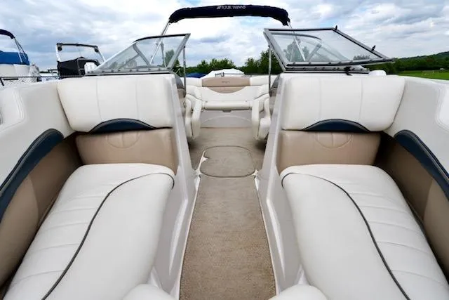 Slide: The Image of 2006 Four Winns 210 Horizon boat interior with white and beige seating, open deck view. - 10