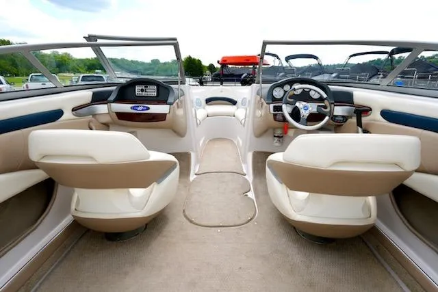 Slide: The Image of Interior of 2006 Four Winns 210 Horizon boat with beige seating and dashboard. - 11