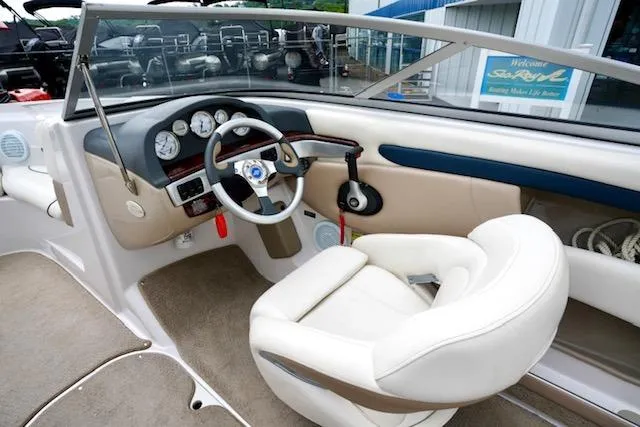 Slide: The Image of Interior view of 2006 Four Winns 210 Horizon boat, featuring steering wheel and dashboard controls. - 12