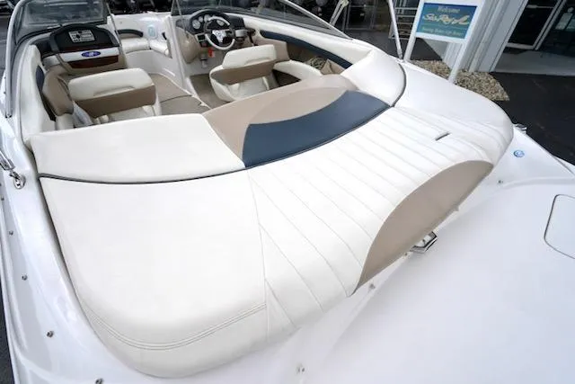 Slide: The Image of 2006 Four Winns 210 Horizon boat interior with white and beige seating. - 16