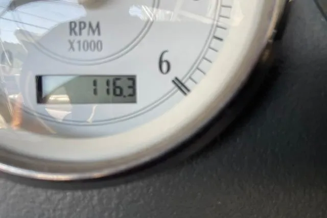 Slide: The Image of Close-up of a 2006 Four Winns 210 Horizon RPM gauge displaying 116.3 hours. - 20