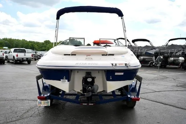 Slide: The Image of 2006 Four Winns 210 Horizon boat on trailer, rear view, parked outdoors. - 6