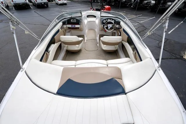 Slide: The Image of 2006 Four Winns 210 Horizon boat interior with beige and white seating, steering wheel, and dashboard. - 8