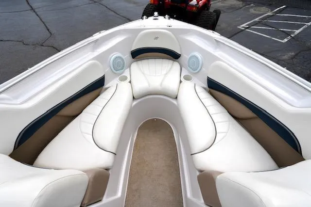 Slide: The Image of 2006 Four Winns 210 Horizon boat interior with white cushioned seating and speakers. - 9