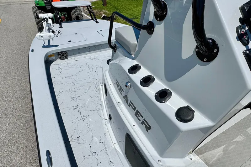 Slide: The Image of 2022 Majek 24 Reaper boat interior with sleek design and fishing rod holders. - 11