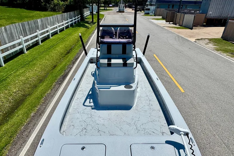 Slide: The Image of 2022 Majek 24 Reaper boat on road, showcasing sleek design and spacious deck. - 14