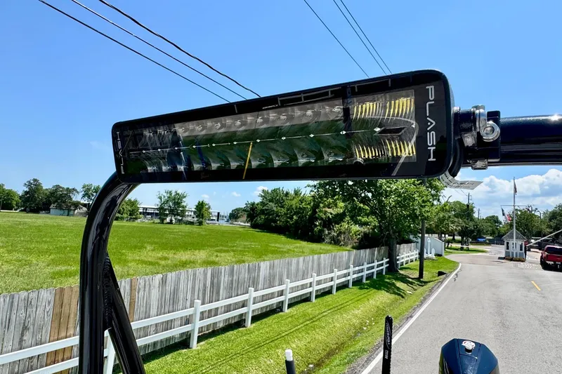 Slide: The Image of LED light bar on 2022 Majek 24 Reaper boat, sunny day, roadside view. - 16