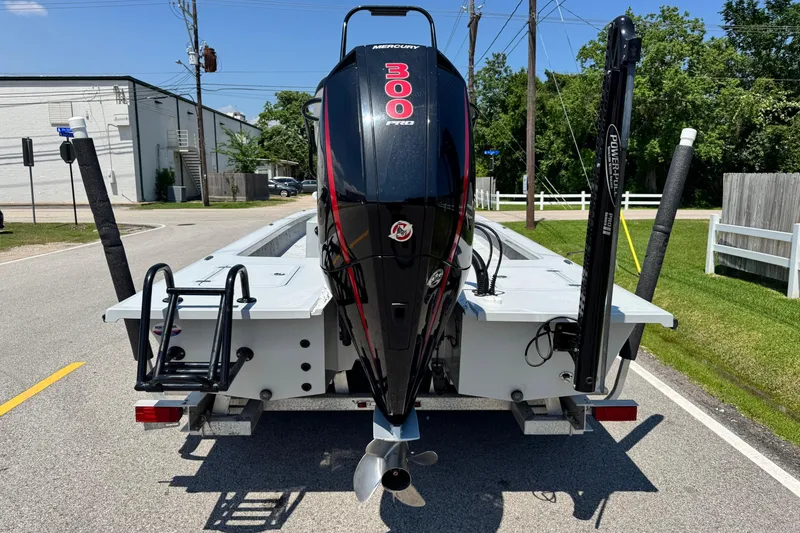 Slide: The Image of 2022 Majek 24 Reaper boat with Mercury 300 engine on a sunny street. - 3