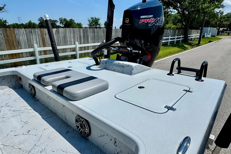 Slide: The Image of 2022 Majek 24 Reaper boat with Mercury Pro XS engine, parked on a sunny street. - 7