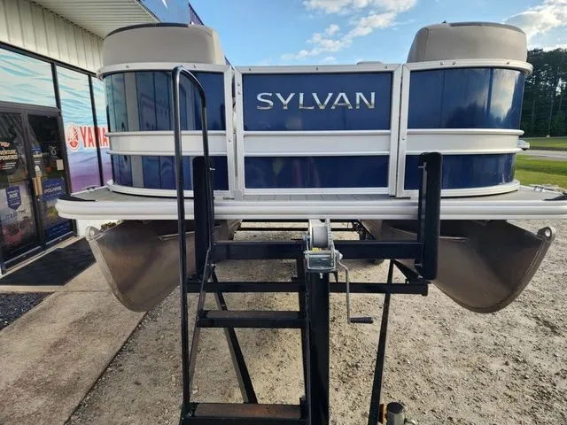 Slide: The Image of 2022 Sylvan L-1 LZ pontoon boat on trailer outside store. - 3